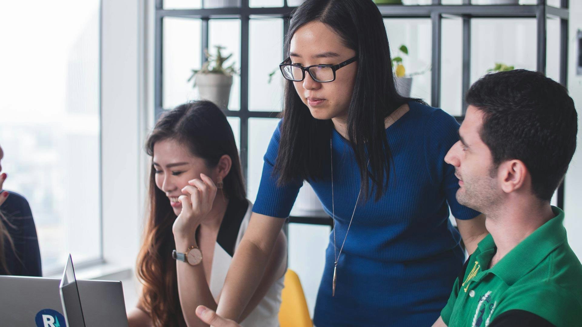 Woman Showing Coworker Something on Computer